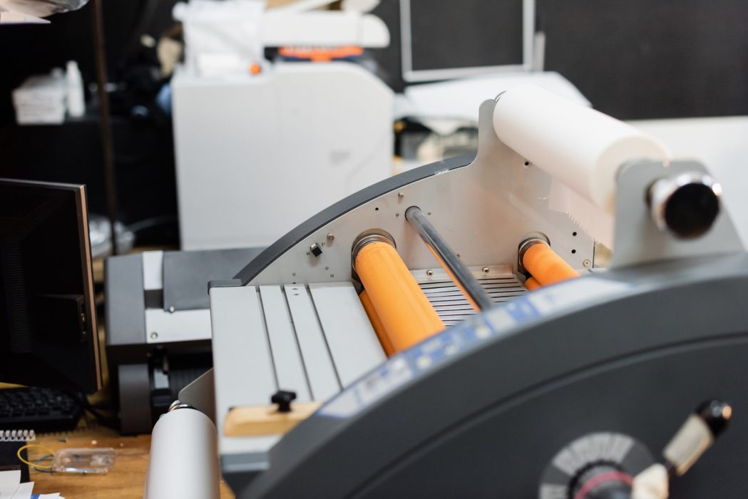 paper roll inside of professional print plotter in copy center