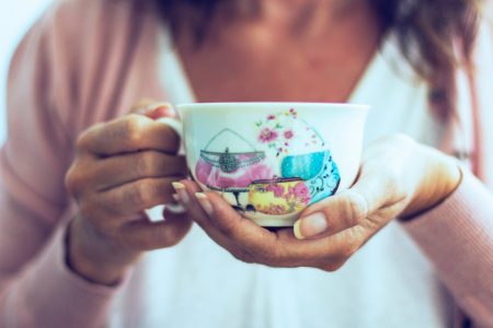 woman-holding-a-cup-of-coffee-with-her-hands-2024-12-04-18-03-01-utc